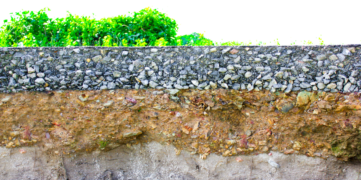 A cross sectional view of layered soil and asphalt